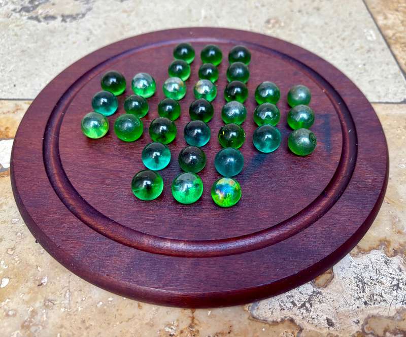 Solitaire game wood green glass marbles