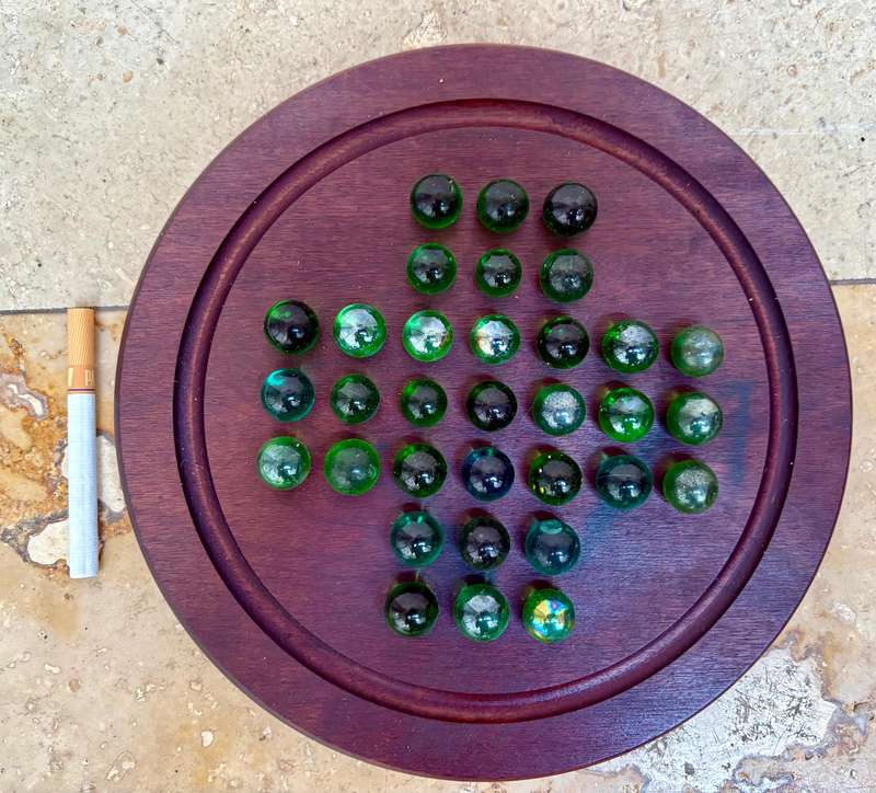 Solitaire game wood green glass marbles