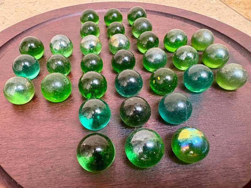 Solitaire game wood green glass marbles