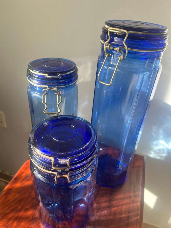 a set of 3 Blue glass jars