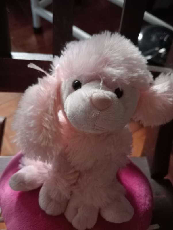 VINTAGE STUFFED DOG ON CUSHION