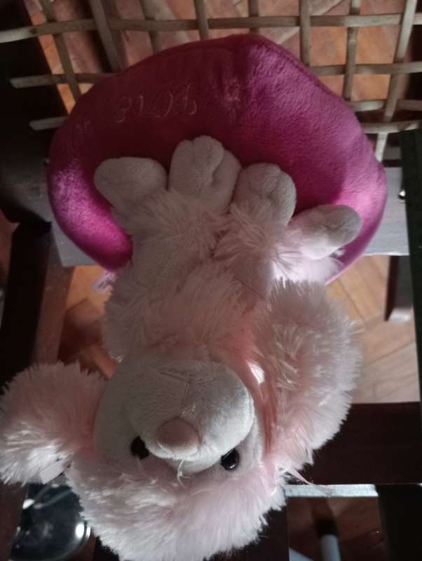 VINTAGE STUFFED DOG ON CUSHION