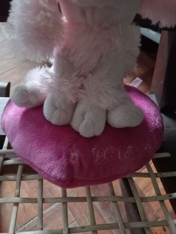 VINTAGE STUFFED DOG ON CUSHION