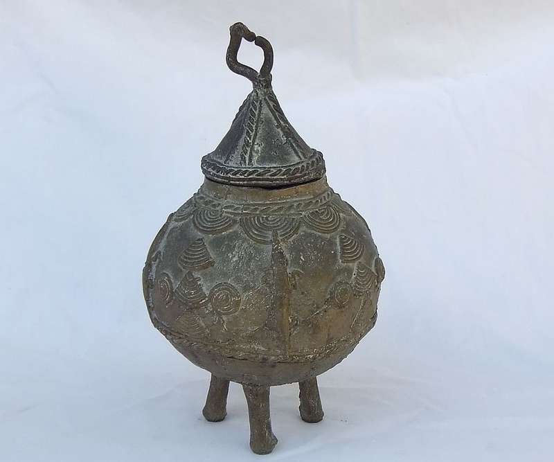 AN OLD WEST AFRICAN TRIBAL BENIN BRONZE URN WITH TRADITIONAL MOTIFS