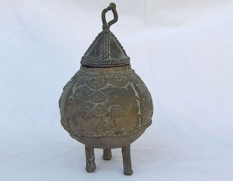 AN OLD WEST AFRICAN TRIBAL BENIN BRONZE URN WITH TRADITIONAL MOTIFS