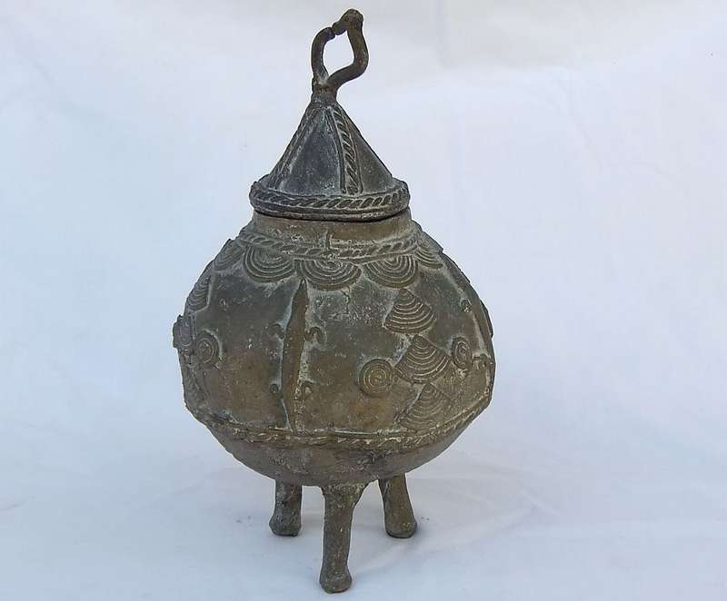 AN OLD WEST AFRICAN TRIBAL BENIN BRONZE URN WITH TRADITIONAL MOTIFS