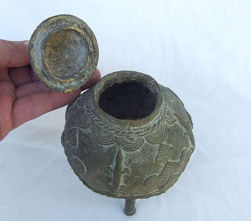 AN OLD WEST AFRICAN TRIBAL BENIN BRONZE URN WITH TRADITIONAL MOTIFS