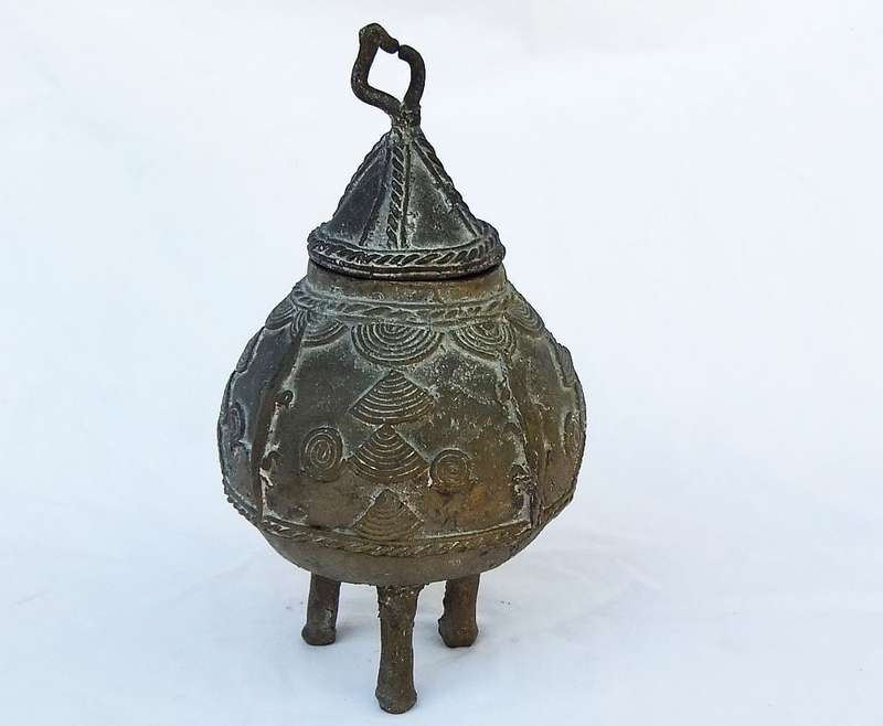 AN OLD WEST AFRICAN TRIBAL BENIN BRONZE URN WITH TRADITIONAL MOTIFS