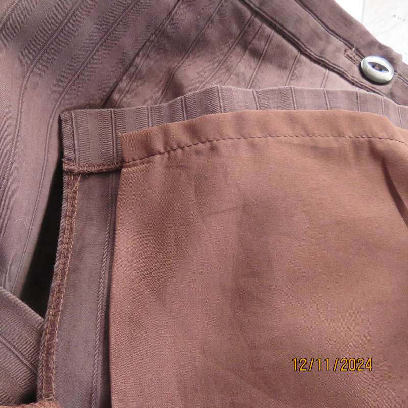 Dark brown striped firm textured stretch polyester pencil lined skirt.Size 38.Zip/pleat at back.