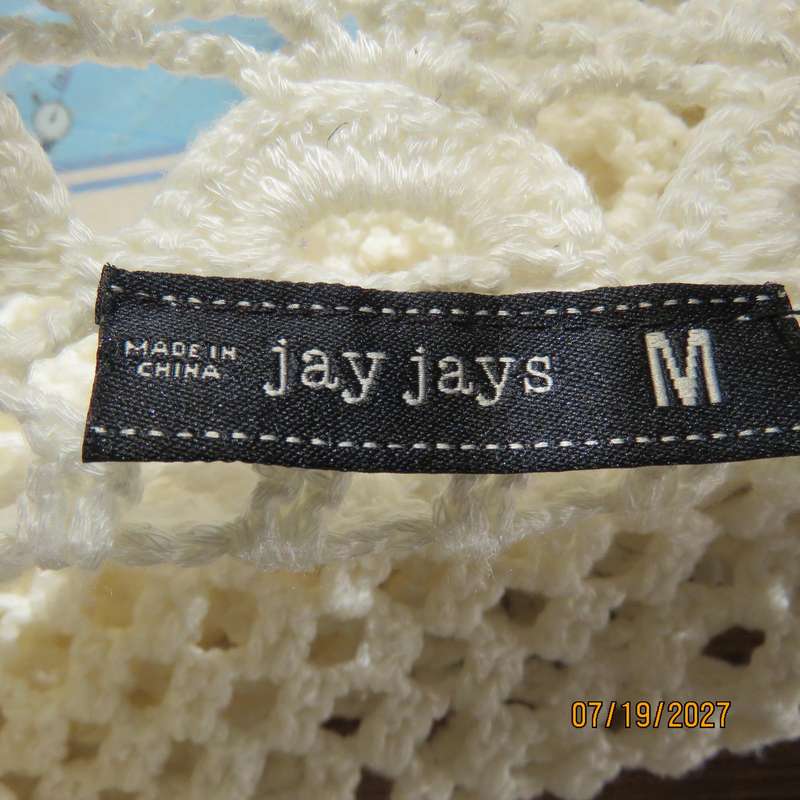 White elegant crochet waistcoat with round edging. The button closure. Size 34-36