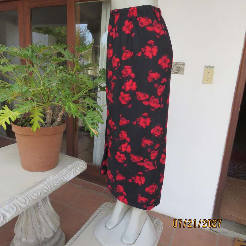 AMARA soft stretch polyester black slightly A-line skirt with red flowers. Size 38