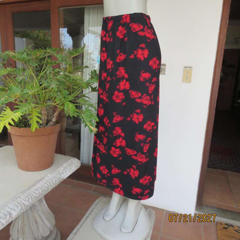 AMARA soft stretch polyester black slightly A-line skirt with red flowers. Size 38