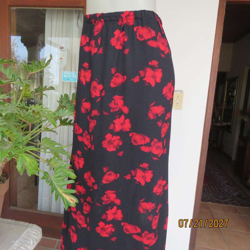 AMARA soft stretch polyester black slightly A-line skirt with red flowers. Size 38