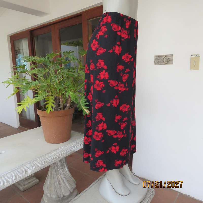 AMARA soft stretch polyester black slightly A-line skirt with red flowers. Size 38