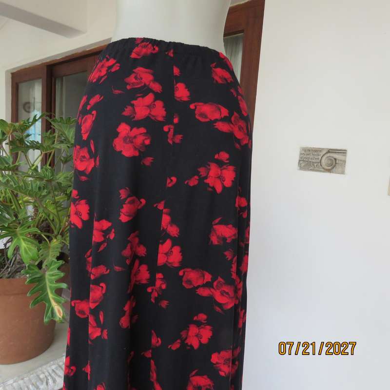 AMARA soft stretch polyester black slightly A-line skirt with red flowers. Size 38