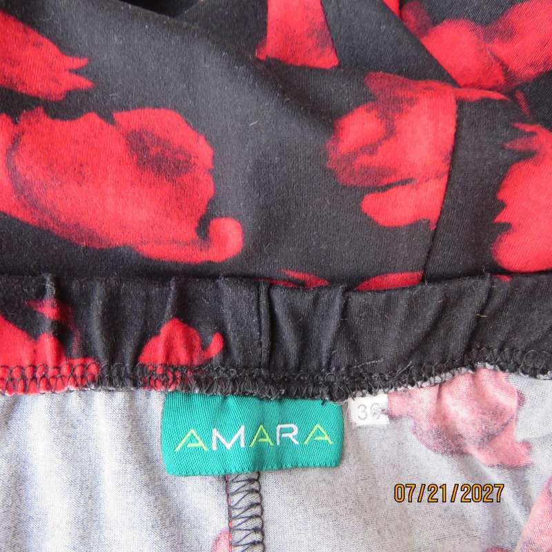 AMARA soft stretch polyester black slightly A-line skirt with red flowers. Size 38