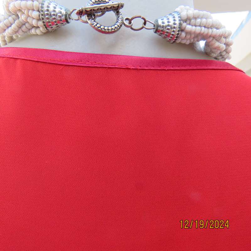 Boutique made cherry red sheer polyester sleeveless top. Satin edging around neckline.Size 38.As new