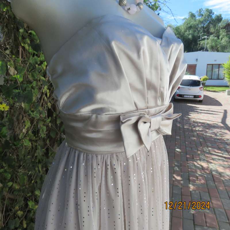 Evening dress in ivory pearl. Strapless poly /satin stretch bodice.Netting/sequin bottom. Size 38.