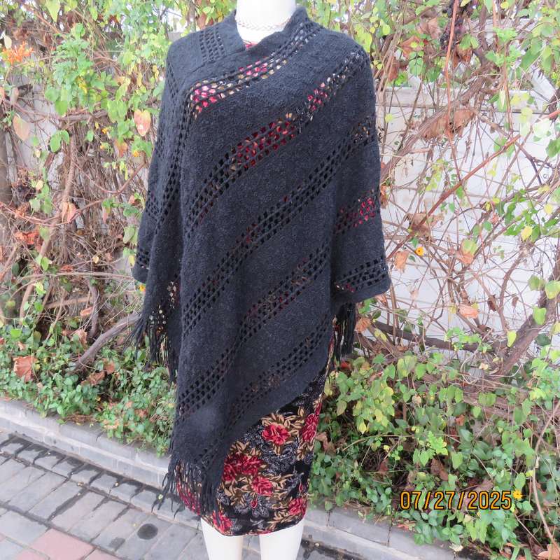 Black acrylic knit throw in pretty pattern. Fringed. Size 34-36.