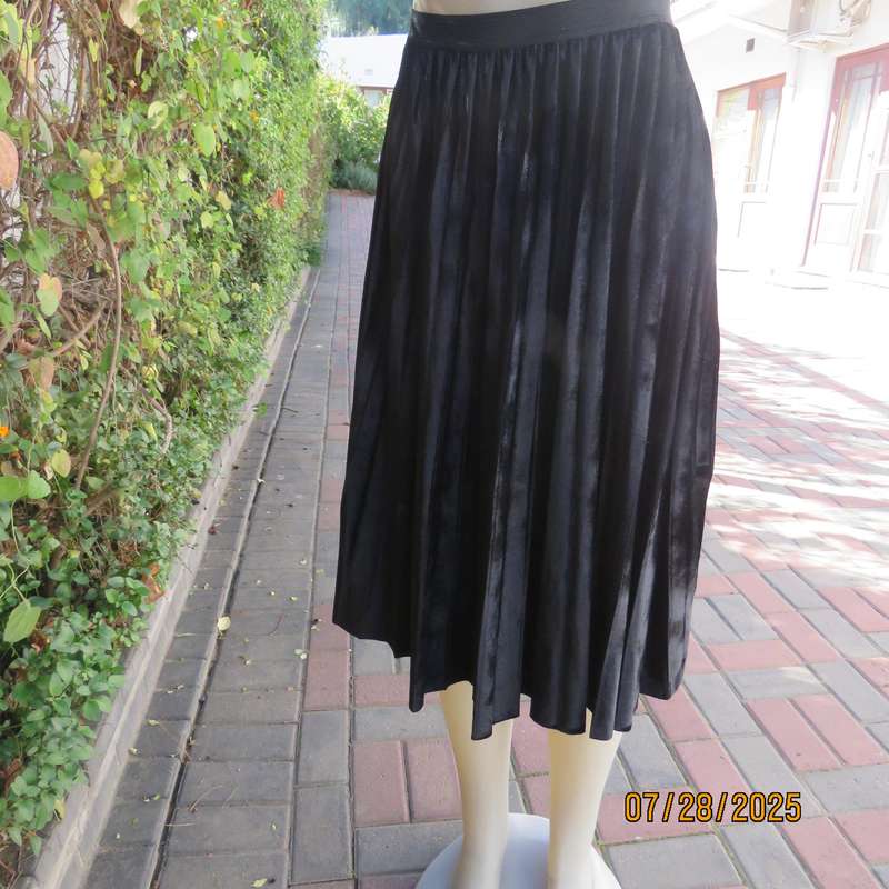 Black permanent pleated flare stretch polyester velour size 32 skirt. Elastic waist.