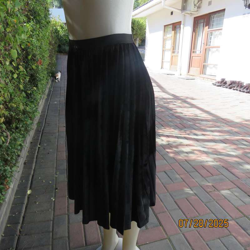 Black permanent pleated flare stretch polyester velour size 32 skirt. Elastic waist.