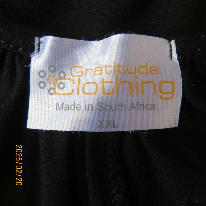 Fabulous GRATITUTE naked shoulder with 3 studded bands black top. Peephole on front. As new cond.