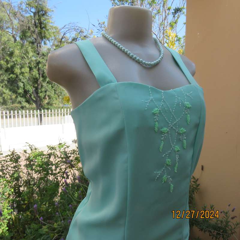 Beautiful emerald green embellished polyester top with shoulder straps. Size 37.Button down back.