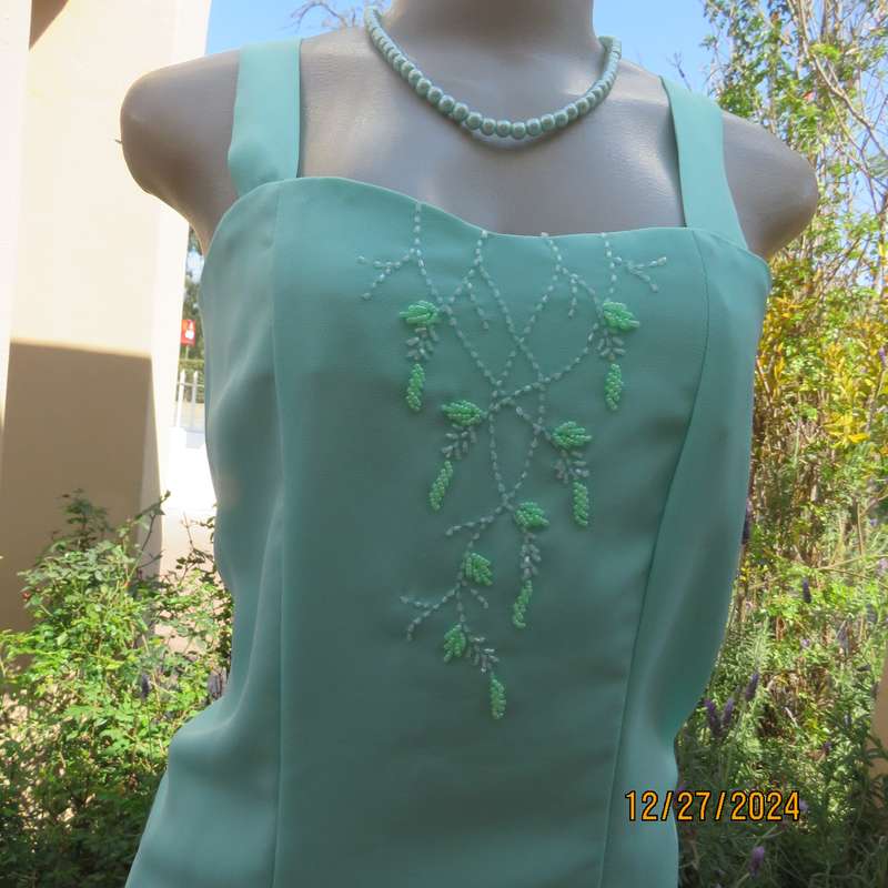 Beautiful emerald green embellished polyester top with shoulder straps. Size 37.Button down back.