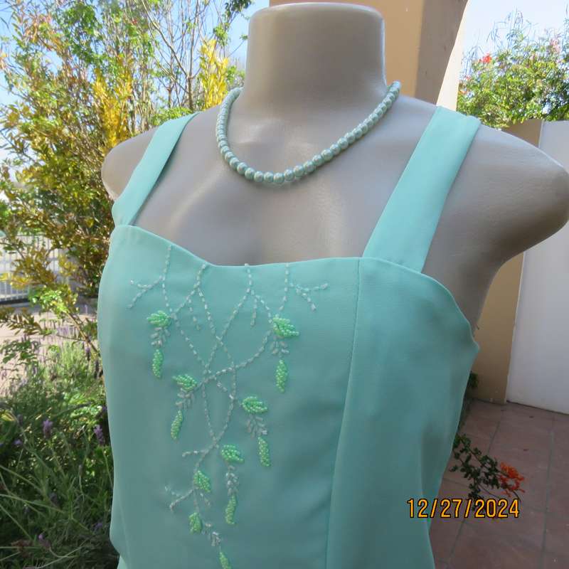Beautiful emerald green embellished polyester top with shoulder straps. Size 37.Button down back.