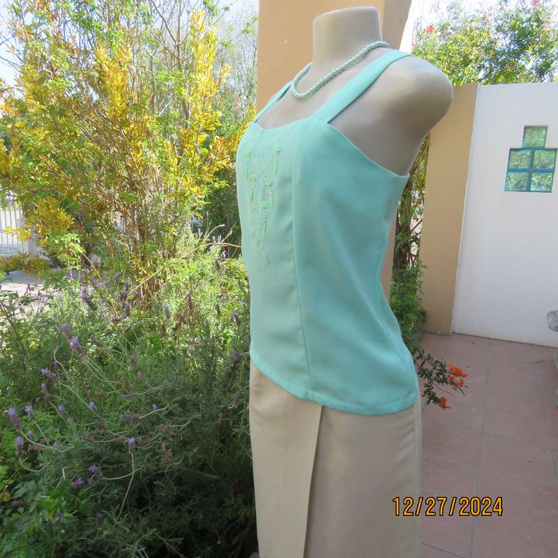 Beautiful emerald green embellished polyester top with shoulder straps. Size 37.Button down back.