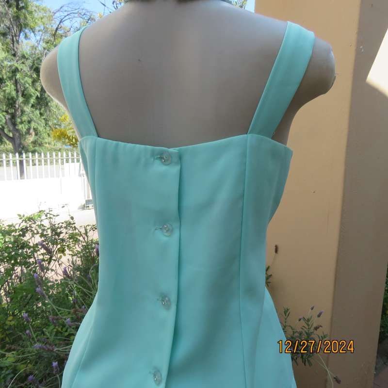 Beautiful emerald green embellished polyester top with shoulder straps. Size 37.Button down back.