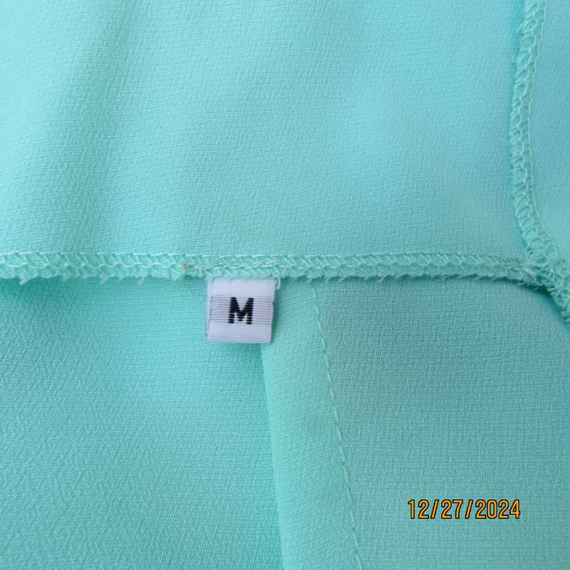 Beautiful emerald green embellished polyester top with shoulder straps. Size 37.Button down back.