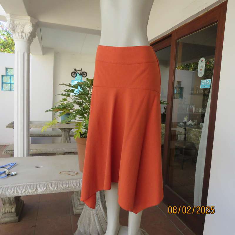 EXACT polyester-rayon high-low burnt orange colour flare skirt. Size 38