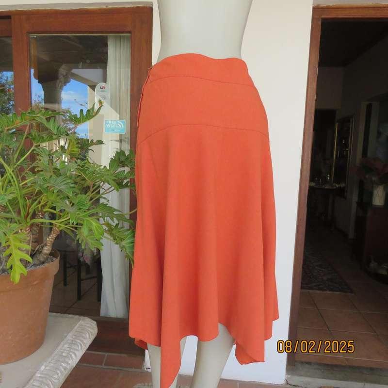 EXACT polyester-rayon high-low burnt orange colour flare skirt. Size 38