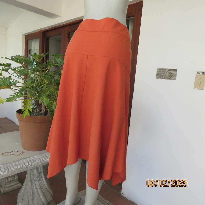 EXACT polyester-rayon high-low burnt orange colour flare skirt. Size 38