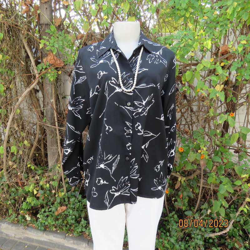 CONCEPTS black silky polyester top with white graphic floral print. Size 40.