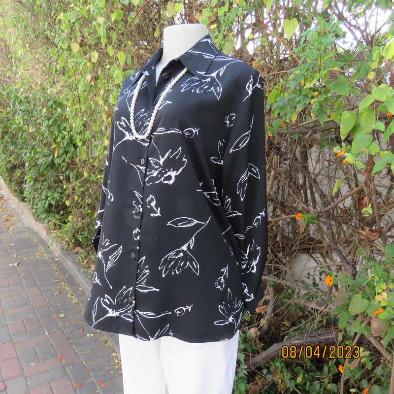 CONCEPTS black silky polyester top with white graphic floral print. Size 40.