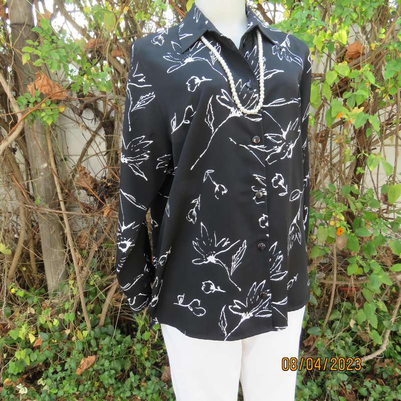 CONCEPTS black silky polyester top with white graphic floral print. Size 40.