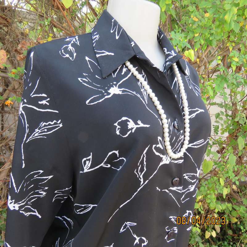 CONCEPTS black silky polyester top with white graphic floral print. Size 40.