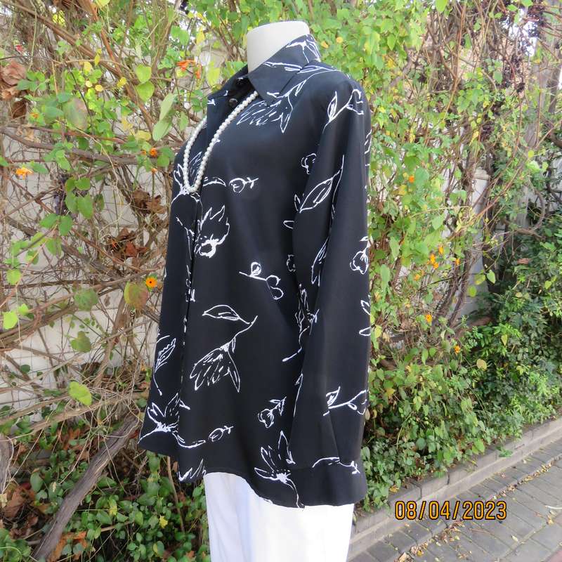 CONCEPTS black silky polyester top with white graphic floral print. Size 40.