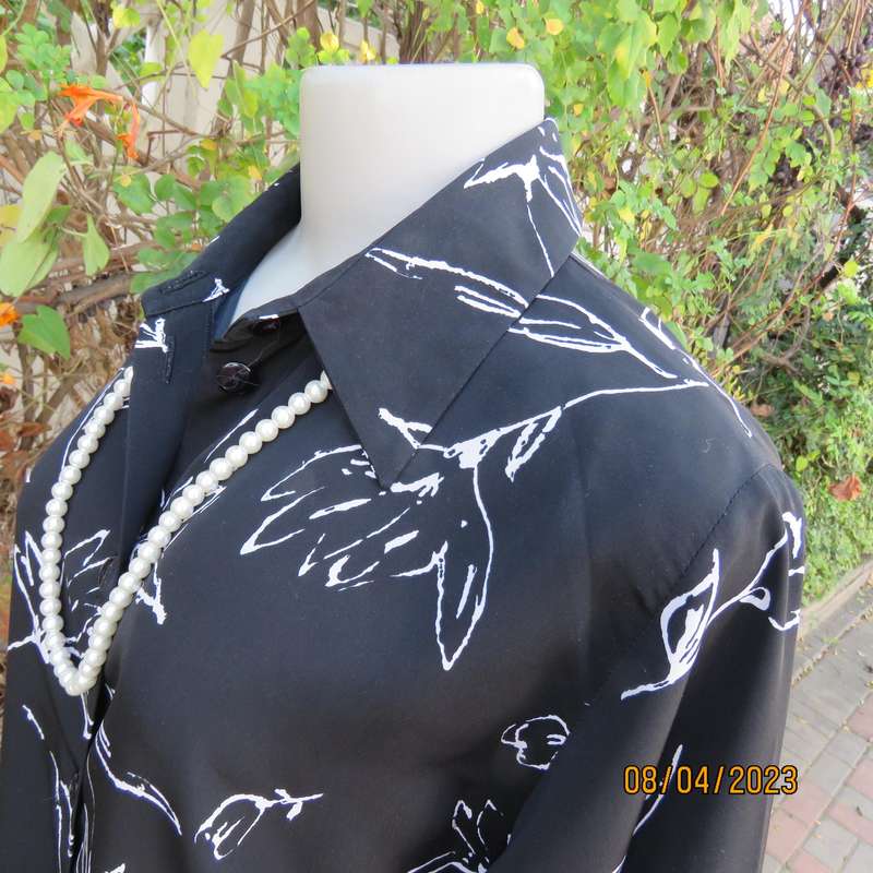 CONCEPTS black silky polyester top with white graphic floral print. Size 40.