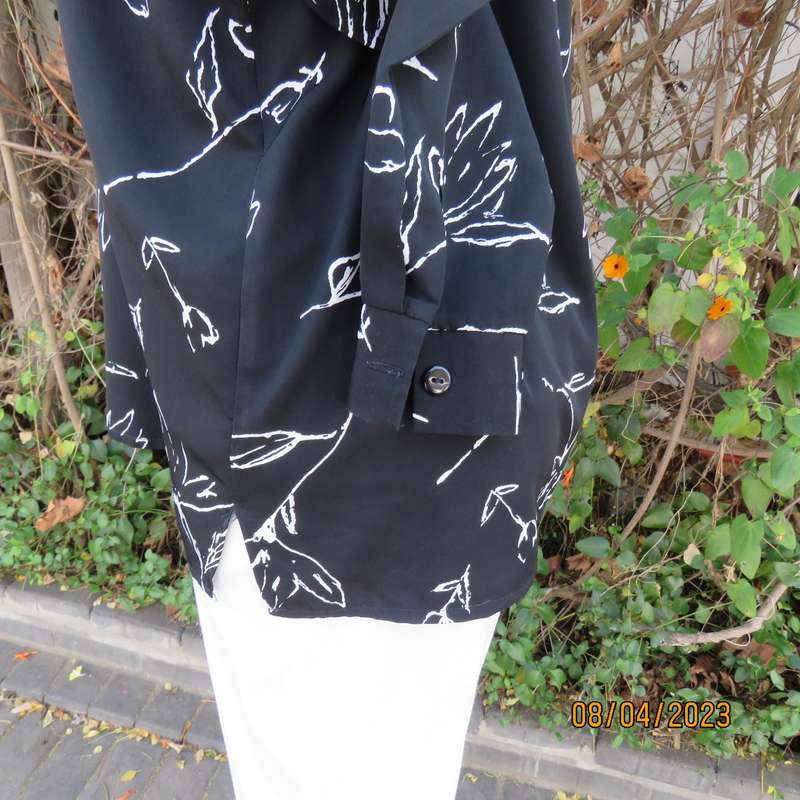 CONCEPTS black silky polyester top with white graphic floral print. Size 40.
