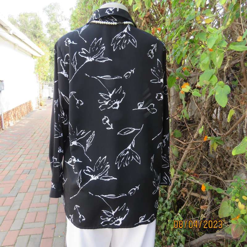 CONCEPTS black silky polyester top with white graphic floral print. Size 40.