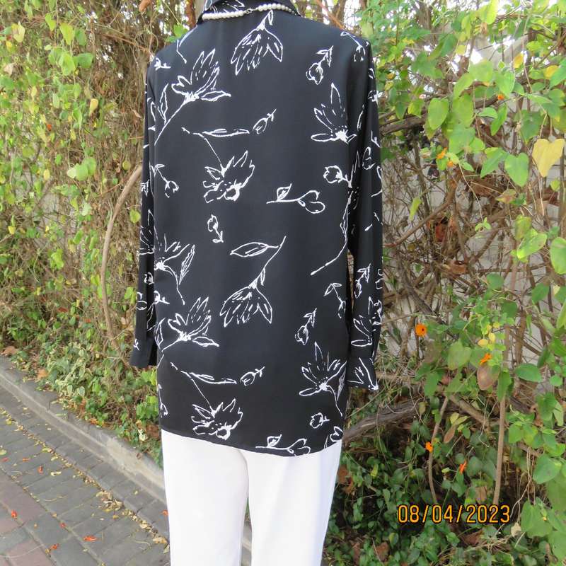 CONCEPTS black silky polyester top with white graphic floral print. Size 40.