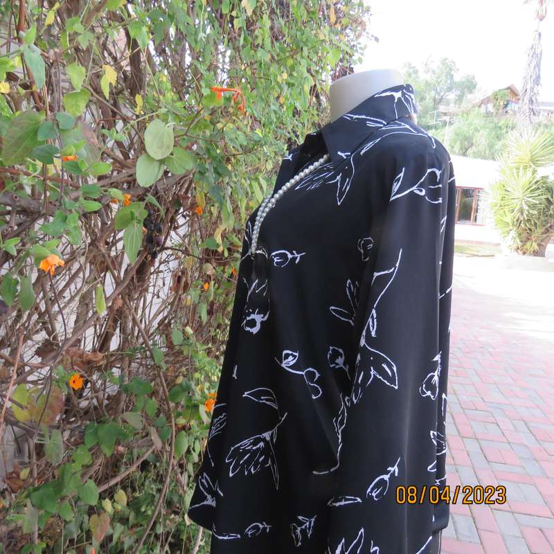 CONCEPTS black silky polyester top with white graphic floral print. Size 40.