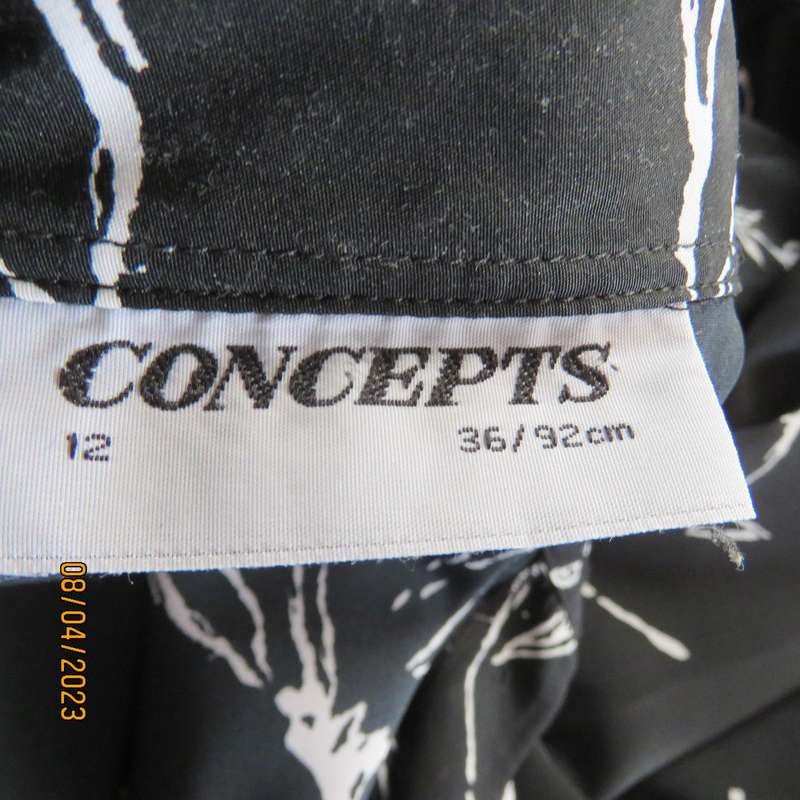 CONCEPTS black silky polyester top with white graphic floral print. Size 40.