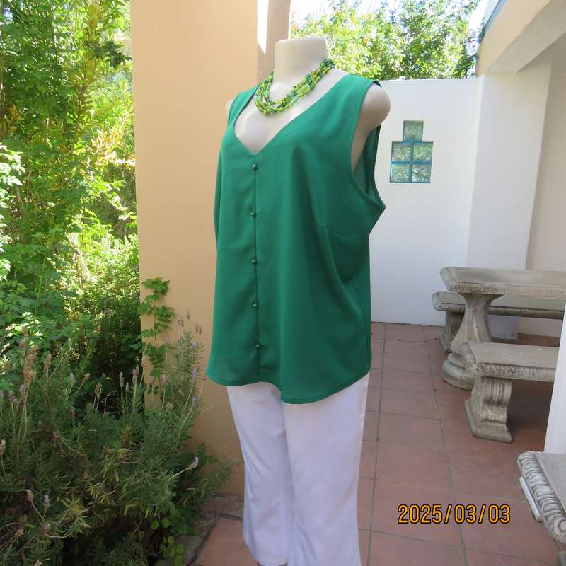 Cool grass green sleeveless V neck top size 42. In polyester. Slip over.Tiny buttons on front.As new
