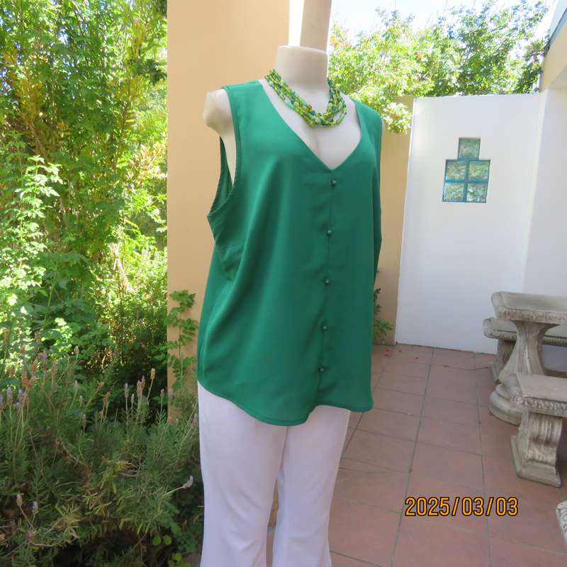 Cool grass green sleeveless V neck top size 42. In polyester. Slip over.Tiny buttons on front.As new