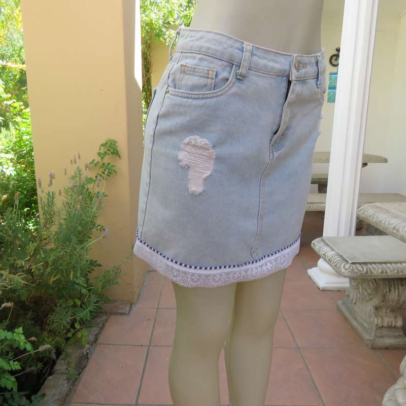 Sexy light blue denim jean distressed look  skirt. Pencil style. Decorative hem. Size 32. As new con