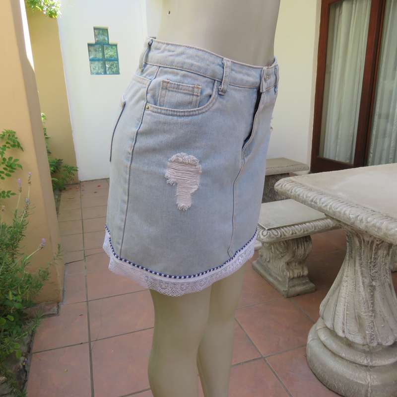 Sexy light blue denim jean distressed look  skirt. Pencil style. Decorative hem. Size 32. As new con